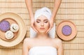 Beautiful, young and healthy woman on bamboo mat in spa salon ha Royalty Free Stock Photo