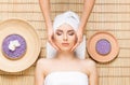 Beautiful, young and healthy woman on bamboo mat in spa salon ha Royalty Free Stock Photo