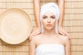 Beautiful, young and healthy woman on bamboo mat in spa salon ha Royalty Free Stock Photo