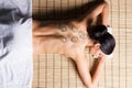 Beautiful, young and healthy woman on bamboo mat in spa salon is having vacuum cupping. Royalty Free Stock Photo