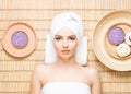 Beautiful, young and healthy woman in spa salon on bamboo mat. S Royalty Free Stock Photo