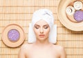 Beautiful, young and healthy woman in spa salon on bamboo mat. S Royalty Free Stock Photo