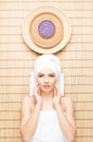 Beautiful, young and healthy woman in spa salon on bamboo mat. S Royalty Free Stock Photo