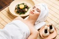 Beautiful, young and healthy woman in spa salon on bamboo mat. S Royalty Free Stock Photo