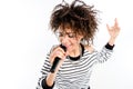 Beautiful young heavy metal singer with microphone singing and gesturing Royalty Free Stock Photo