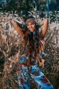 Beautiful young hippie style woman close up portrait at sunset on a field Royalty Free Stock Photo