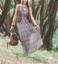 Beautiful young hippie woman standing among the trees in the Park Royalty Free Stock Photo