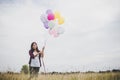 Beautiful young hipster woman holding with colorful of balloons Royalty Free Stock Photo
