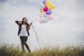 Beautiful young hipster woman holding with colorful of balloons Royalty Free Stock Photo