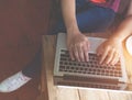 beautiful young hipster woman`s hands busy working on her laptop sitting at wooden table in a coffee shop Royalty Free Stock Photo