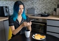 Beautiful young hipster woman taking photo of her breakfast at modern kitchen Royalty Free Stock Photo