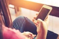 Beautiful young hipster woman using smart phone in coffee shop Royalty Free Stock Photo