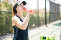 Beautiful tennis player drinking energy drink