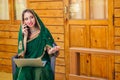 Beautiful and young indian business woman in traditional india sari working with laptop veranda at home.asian student Royalty Free Stock Photo