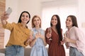 Beautiful young ladies with champagne taking selfie. Women`s Day