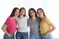 Beautiful young ladies in jeans and colorful t-shirts. Woman`s Day Royalty Free Stock Photo