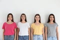 Beautiful young ladies in jeans and colorful t-shirts on background. Woman`s Day Royalty Free Stock Photo