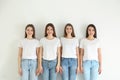 Beautiful young ladies in jeans and white t-shirts on background. Woman`s Day Royalty Free Stock Photo