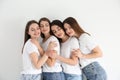 Beautiful young ladies in jeans and white t-shirts on background. Woman`s Day Royalty Free Stock Photo