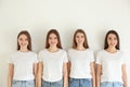 Beautiful young ladies in jeans and white t-shirts on background. Woman`s Day Royalty Free Stock Photo