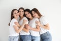 Beautiful young ladies in jeans and white t-shirts on background. Woman`s Day Royalty Free Stock Photo