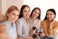 Beautiful young ladies with wine taking selfie. Women`s Day