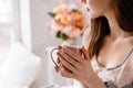 Beautiful young lady with cup of morning coffee