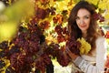 Beautiful young lady in grape vineyard