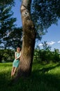 Beautiful young lady having fun in spring forest on sunny spring day