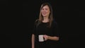 A Lady Holding a Cup Against a Black Background