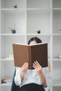 Beautiful young lady reading exciting story, enjoying lazy morning Royalty Free Stock Photo