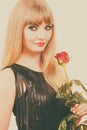 Beautiful young lady with red rose. Royalty Free Stock Photo