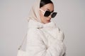 Beautiful young lady in a white faux fur coat