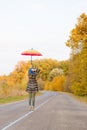 Beautiful young lady with umbrella jumping on Royalty Free Stock Photo