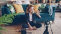 Beautiful young lady vlogger is recording video about new make-up products and tools using camera on tripod. Blogger is Royalty Free Stock Photo