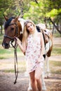 Beautiful young lady wearing vintage dress riding a horse at sun Royalty Free Stock Photo