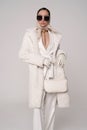 Beautiful young lady in a white faux fur coat Royalty Free Stock Photo