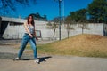 Beautiful young latina dancing happily in the street while partying with jumps and somersaults. Concept of joy, street dance, hip