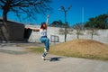 Beautiful young latina dancing happily in the street while partying with jumps and somersaults. Concept of joy, street dance, hip