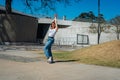 Beautiful young latina dancing happily in the street while partying with jumps and somersaults. Concept of joy, street dance, hip