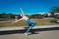 Beautiful young latina dancing happily in the street while partying with jumps and somersaults. Concept of joy, street dance, hip