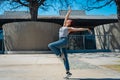 Beautiful young latina dancing happily in the street while partying with jumps and somersaults. Concept of joy, street dance, hip