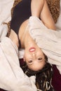 Beautiful young Latina woman reclining into a tan blanket Royalty Free Stock Photo