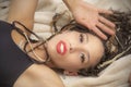 Beautiful young Latina woman reclining into a tan blanket Royalty Free Stock Photo