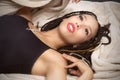 Beautiful young Latina woman reclining into a tan blanket Royalty Free Stock Photo