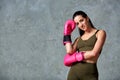 Beautiful young girl boxing gloves near the wall. Royalty Free Stock Photo