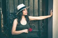 Beautiful young latino woman with panama hat portrait and rose i Royalty Free Stock Photo