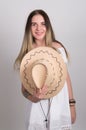 Beautiful young leggy blond Country girl in a litl white dress and cowboy hat with a guitar Royalty Free Stock Photo