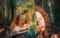 Beautiful young lovely sexy woman redhead ginger with curly red hair natural in the forest n nature, leans head tenderly against Royalty Free Stock Photo