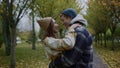 Beautiful young lovers kissing romantically in autumn park. Close up of couple.